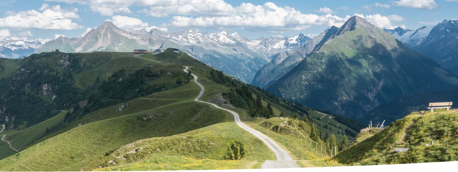 Path along a mountain ridge with a panoramic view.