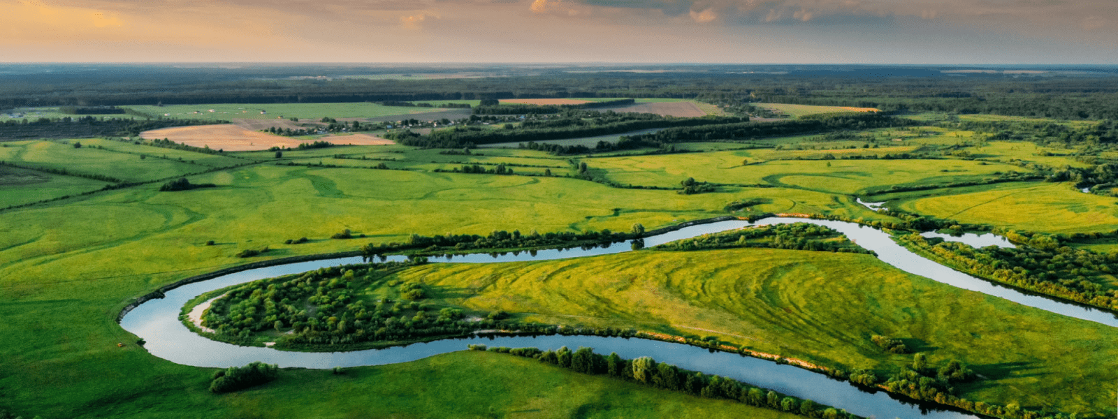 freshwater header - meandering river through green fields