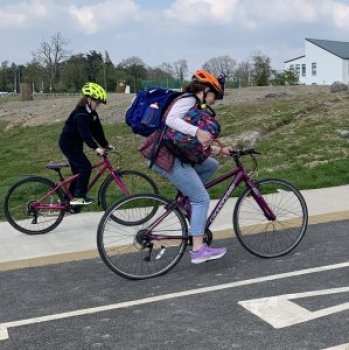 Two people cycling on a cycleway