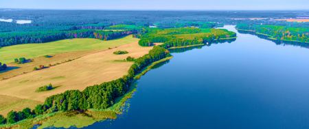 german landscape - green space by big lake flowing into river