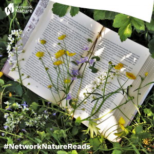 nn reads june - book pages on grass with flowers overlapping