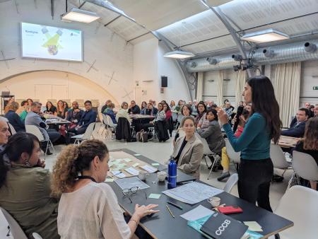 A group of people in a room discussing standards.