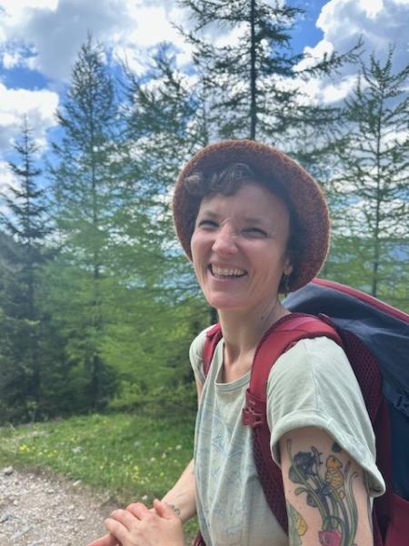 Image of smiling person with a hat enjoying the outdoors