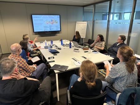 a group of people discussing around the table