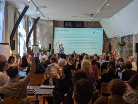 people with hands up in annual networknature event conference