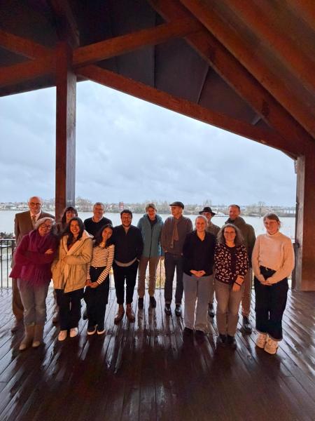 Group of people standing near water.