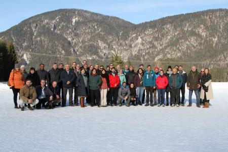 Group photograph of the WILDCARD consortium standing in snow with mountains behind them.