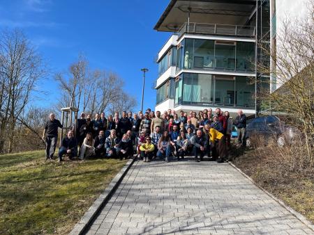 Wildcard consortium members gathered outside a building.