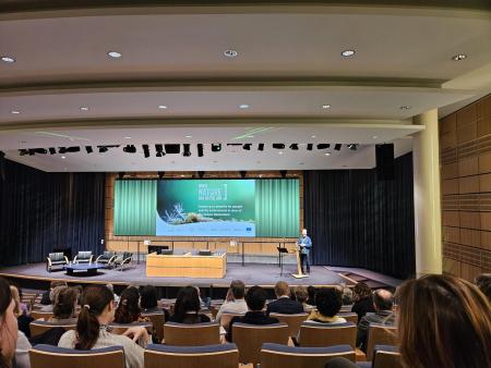 Lecture theatre with people watching a presentation.