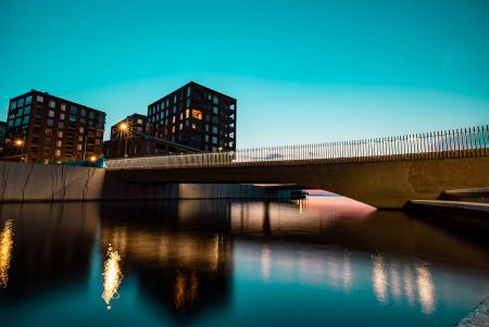 Sunset over high-rise buildings and a bridge on the Tampella canal in Tampere, Finland