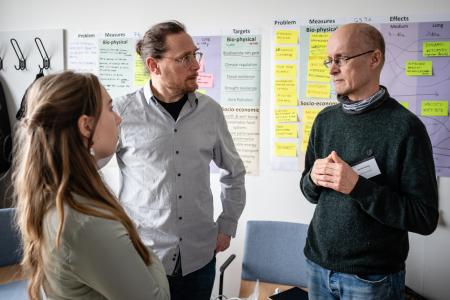Three people talking in a room