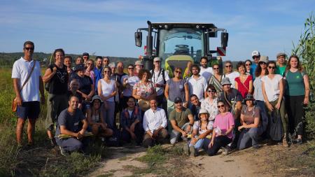 A group photo by a tractor