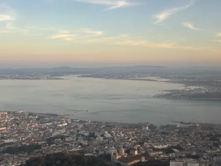 Sunset above the city and water body