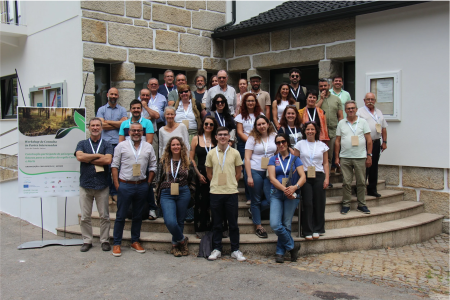 Workshop participants standing on steps outside a building. 