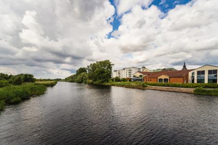 the Helge river in Sweden with buildings on the right hand side bank.