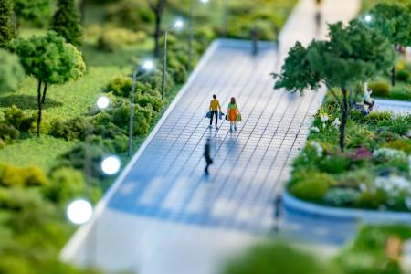 architecture model of people walking through green space