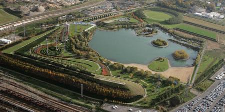 An artifically constructed wetland surrounded by greenspace and planting.