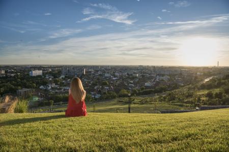 Person sitting on a hill looking out across Oradea.
