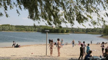 People on a sandy beach park near the shore.