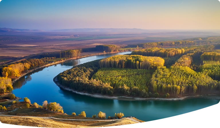 Sunrise over a large river meander.