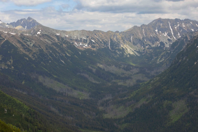 A view of the high Tatras mountains with steep sided mountains and deep valleys.