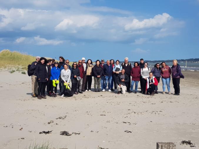 A group of the field excursion participants standing on the beach for a group photograph.