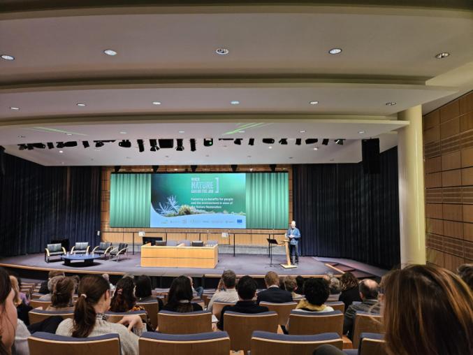 Lecture theatre with people watching a presentation.
