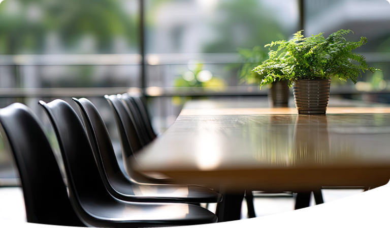 Boardroom with nature in the background and desk plant
