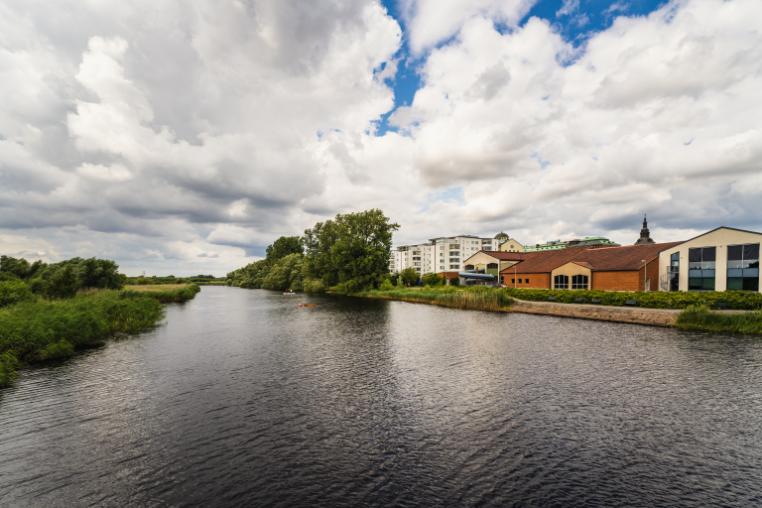 the Helge river in Sweden with buildings on the right hand side bank.