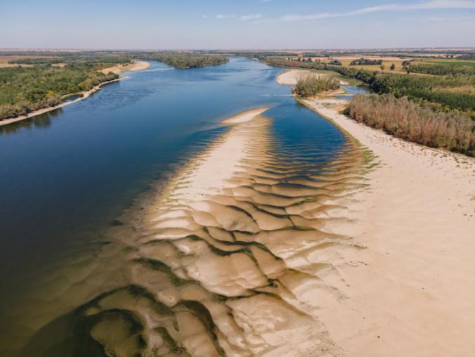 freshwater lake with sand and grass