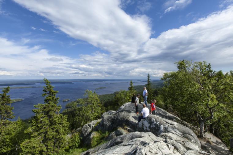 UKKO-KOLI HILL, FINLAND ON JULY 05. View of lake Pielinen from a rock, cliff on July 05, 2017 in Ukko-Koli Hill, Finland. Unidentified people at the outlook. 