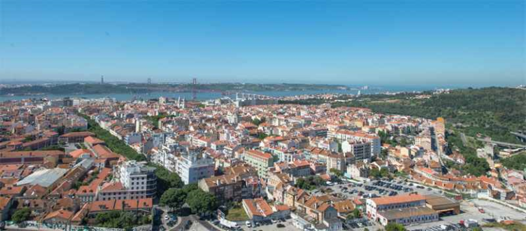 A view of Vale de Alcantara, Lisbon with greenspace and the ocean adjacent to the urban area.