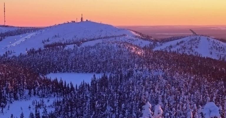 Ruka-Kuusamo forested area covered in snow at sunset.