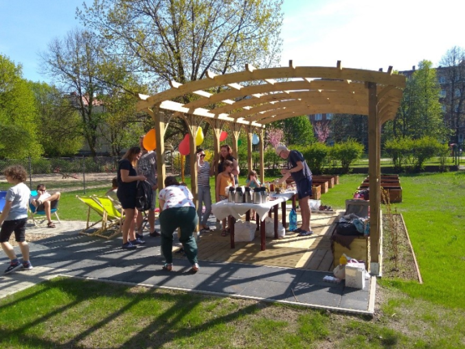Children and adults at an event in a park.
