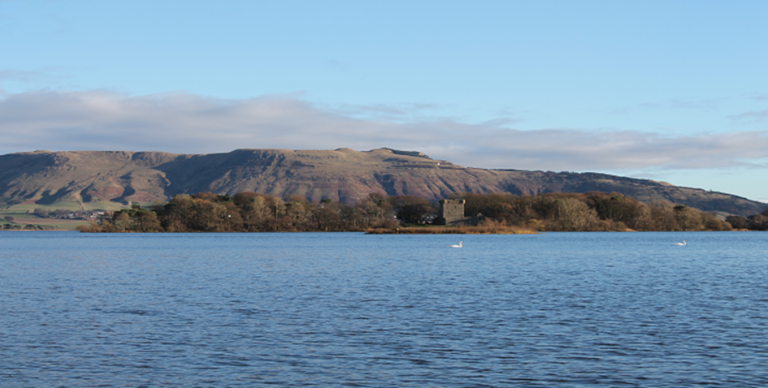 A view of distant mountains with Loch Leven in the foreground.