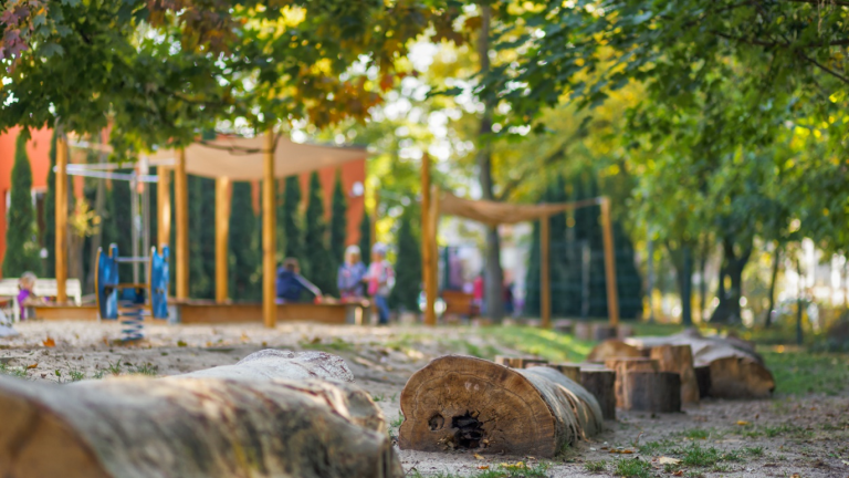 A natural play area with logs to balance on in a pocket park in Poznan.